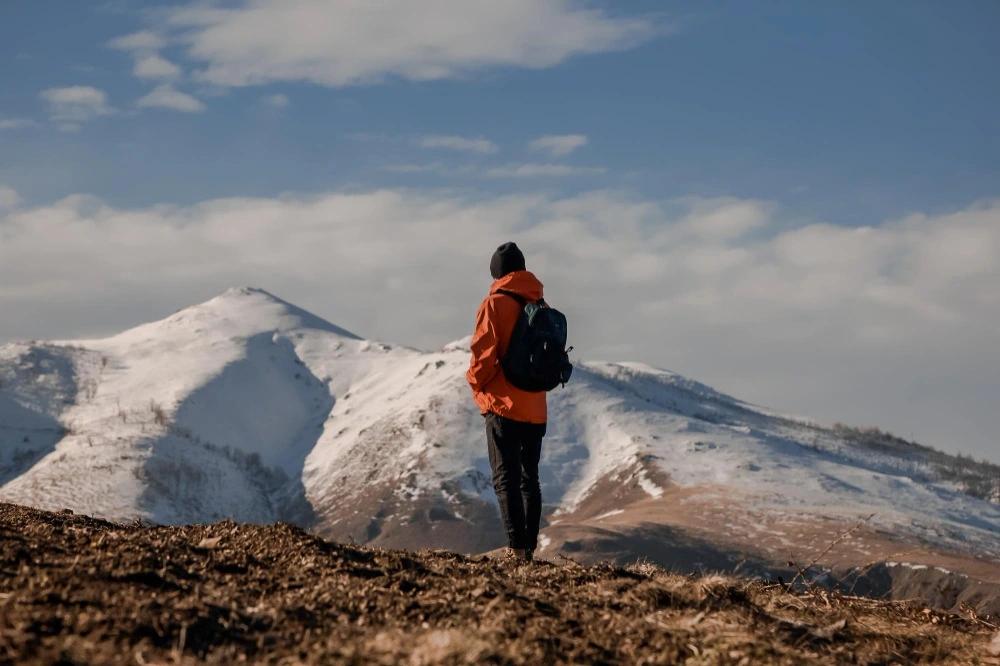 A man on the top of the mountain at the best time for trekking in nepal